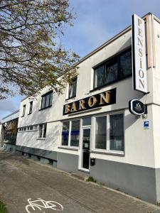 a baronial building with a sign that reads baron at Pension Baron in Fürth