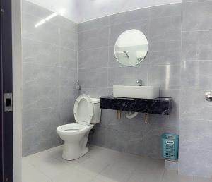 a bathroom with a toilet and a sink and a mirror at Thắng Hà Hotel in Ho Chi Minh City