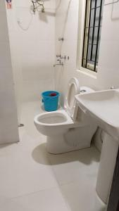 a bathroom with a white toilet and a sink at Hotel DR Retreat in Pakhyong