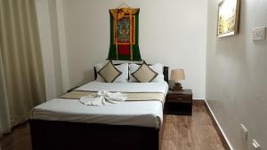 a bedroom with two beds with a bow on top at Hotel DR Retreat in Pakhyong