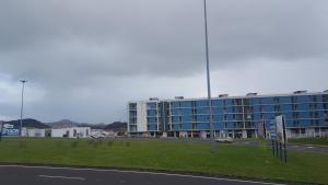 a large blue building on the side of a road at Apartamento Vista Deslumbrante in Ponta Delgada