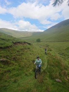 a group of people riding motorcycles on a grassy hill at Galtee Glamping in wooden yurt in Mitchelstown