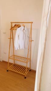 a clothes rack with a white shirt and tie on it at Civico 16 in Sulmona +37 photos