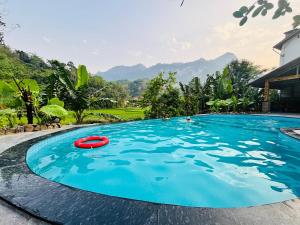 a swimming pool with a red frisbee in the water at Ba Be Legend Hotel & Tours in Ba Be18