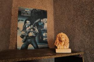 a lion statue sitting on a shelf next to a book at La Cabane Rasta - Mar Lodj in Mar Lodj