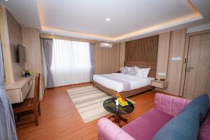 a hotel room with a bed and a couch at Hotel Sampada Boutique in Pokhara