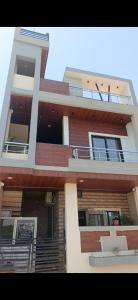 a tall building with balconies and stairs on it at Hari Har HOME STAY FULLY AC in Ujjain