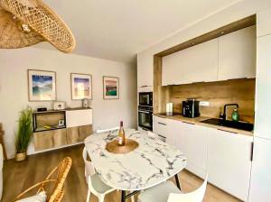 a kitchen with a table with a candle on it at Coconing Plage Pléneuf Val André in Pléneuf-Val-André +7 photos