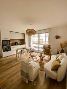 a living room with a couch and a table at Coconing Plage Pléneuf Val André in Pléneuf-Val-André