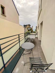 a balcony with chairs and a table on a building at Coconing Plage Pléneuf Val André in Pléneuf-Val-André
