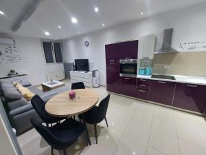 a kitchen and living room with a table and a couch at Apartment Alex in Rijeka