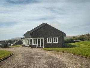 a house on a gravel road at Dingle Mist in Dingle