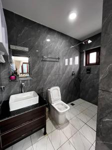 a bathroom with a toilet and a sink at Mandala Resorts & Events in Panepa