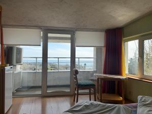 a bedroom with a bed and a window with a view at Villa Climate Guest House in Varna City