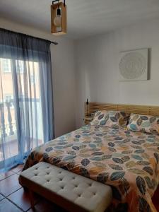 a bedroom with a bed and a large window at Sun Home Arinaga in Arinaga