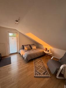 a bedroom with a bed and a table and a couch at Im Wald in Gleiszellen-Gleishorbach