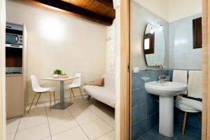 a small bathroom with a sink and a table at Porta delle Botteghelle in Trapani +87 photos
