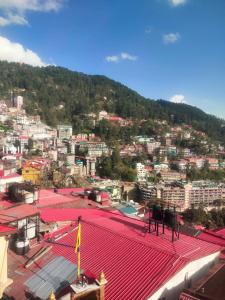 a view of a city with a red roof at HideOut The Mall in Shimla