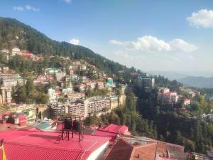 a view of a city on a mountain at HideOut The Mall in Shimla