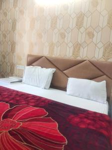 a bedroom with a large bed with a red blanket at HideOut The Mall in Shimla +16 photos