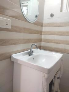 a bathroom with a sink and a mirror at HideOut The Mall in Shimla
