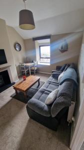 a living room with a couch and a table at Penbryn Holidays, Barmouth in Barmouth