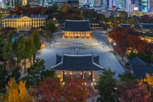 an overhead view of a pagoda in a city at night at STR Stay Bangbae in Seoul