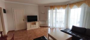 a living room with a couch and a flat screen tv at VILLA AURORA YourCroatiaHoliday in Savudrija