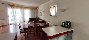 a kitchen and dining room with a table and chairs at VILLA AURORA YourCroatiaHoliday in Savudrija