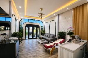 a living room with a couch and a table at Happy Life Hotel DaLat in Da Lat