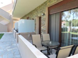 a kitchen and dining area with a table and chairs at Aroma Villa & Studios in Limenas