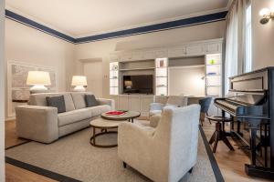 a living room with a couch and a piano at Brunelleschi Prestige by MMega in Florence
