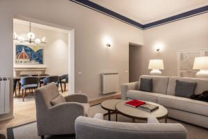 a living room with a couch and chairs and a table at Brunelleschi Prestige by MMega in Florence +16 photos