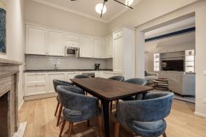 a kitchen with a wooden table and blue chairs at Brunelleschi Prestige by MMega in Florence