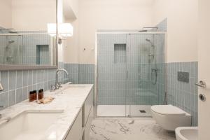 a bathroom with a shower and a toilet and a sink at Brunelleschi Prestige by MMega in Florence