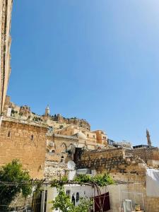 a view of a building with a mountain at Şahran konaği in Mardin