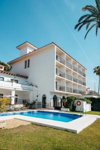 a building with a swimming pool in front of a building at Arcos de Montemar in Torremolinos