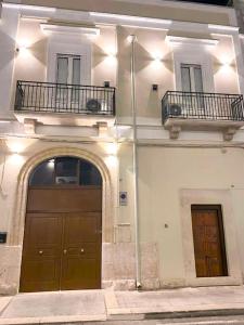 a large building with two doors and a balcony at B&B Palazzo La Rosa in Altamura