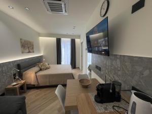 a living room with a bed and a table in a room at Palazzo delle Belle in Catania