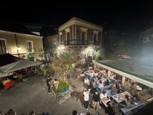 an overhead view of a group of people sitting at tables at Palazzo delle Belle in Catania