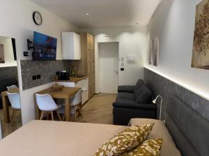 a living room and kitchen with a couch and a table at Palazzo delle Belle in Catania