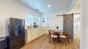 a kitchen with a table and a refrigerator at The Beach House in Ocean City