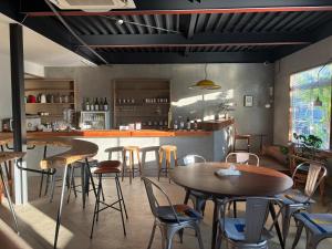 a restaurant with tables and chairs in a room at Lemonsea Onomichi in Onomichi