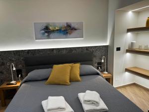 a bedroom with a bed with two towels on it at Palazzo delle Belle in Catania