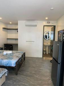 a living room with a table and a refrigerator at Peaceful Turtle Camp in San Francisco +7 photos