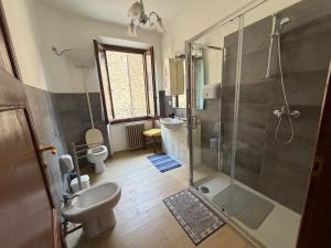 a bathroom with a shower and a sink and a toilet at Incanto dei sibillini- Piazza Perfetti 16 in Sarnano