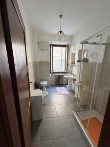 a bathroom with a shower and a toilet and a sink at Incanto dei sibillini- Piazza Perfetti 16 in Sarnano +11 photos