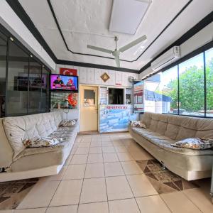 a living room with two couches and a tv at Kervansaray Hotel in Pamukkale