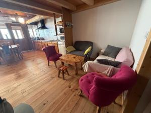a living room with a couch and a table at La Marguerite in Aigueblanche