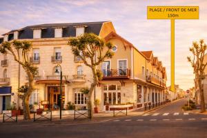 a building on a street with a street sign at LOGIS Hotel Majestic Chatelaillon Plage - La Rochelle in Châtelaillon-Plage +23 photos